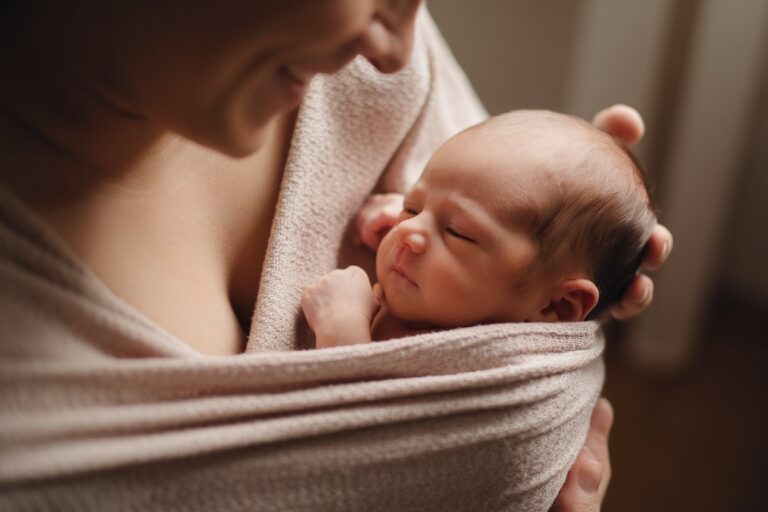 Parent babywearing newborn peacefully