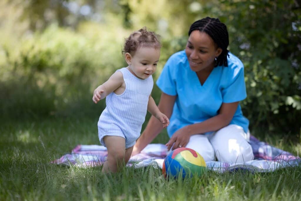 Child confidently explores near a smiling caregiver, illustrating a secure attachment base